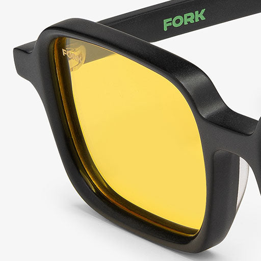 Black sunglasses with yellow lenses and 'FORK' branding on a white background